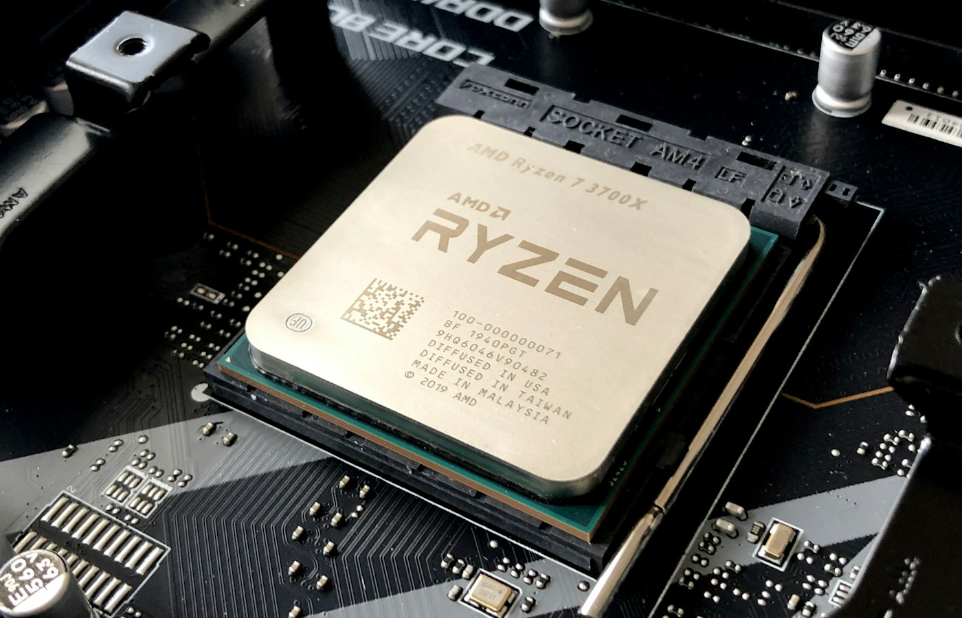 Close-up of a desktop CPU seated on a motherboard under hard directional light