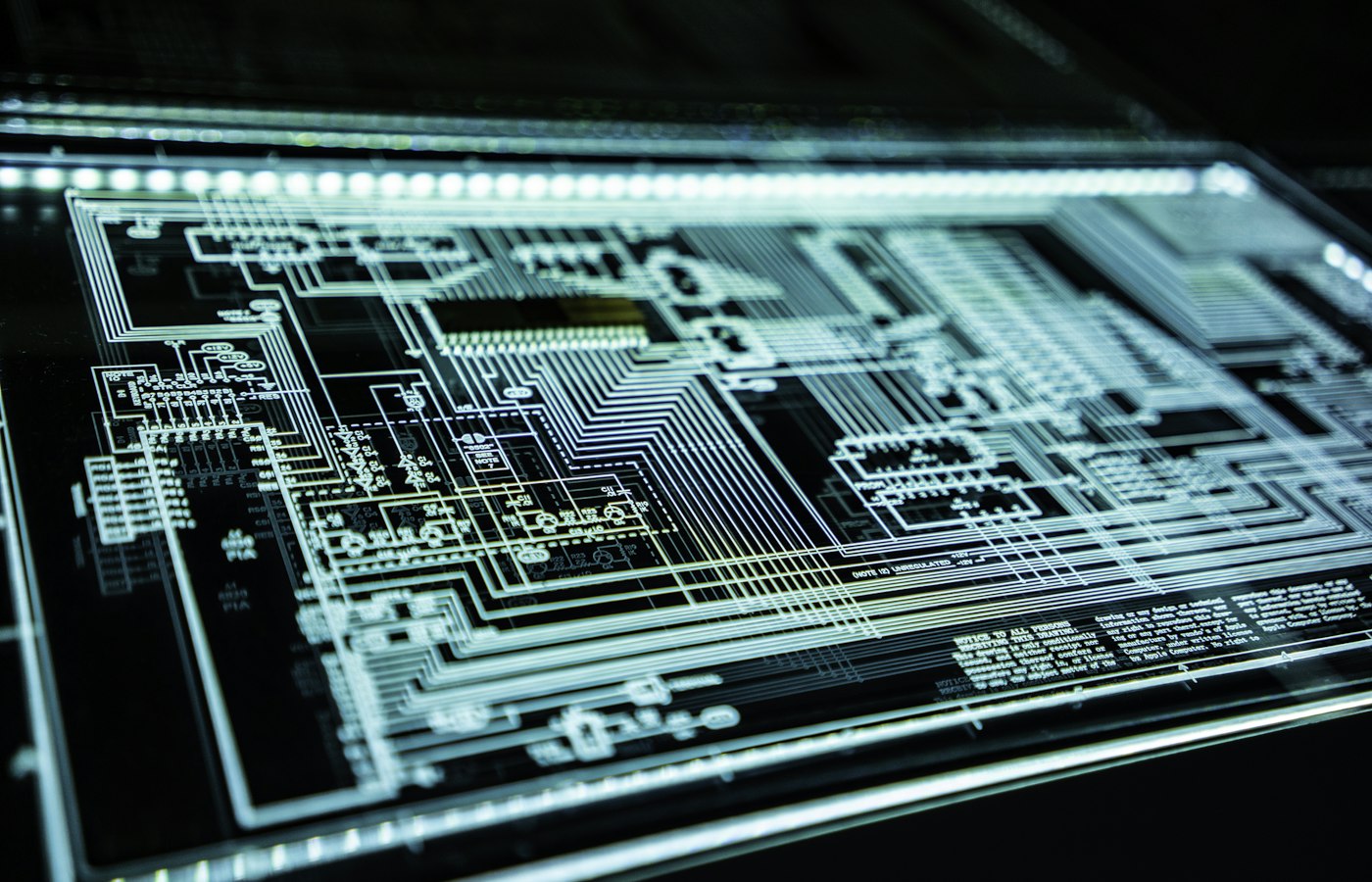 Macro photograph of illuminated circuit traces on a printed circuit board